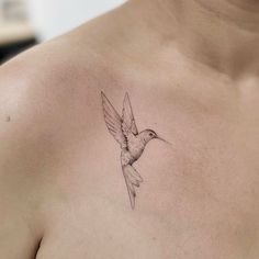 a small bird tattoo on the chest