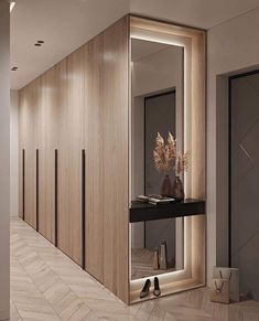 the hallway is lined with wooden walls and flooring, along with a large mirror on the wall