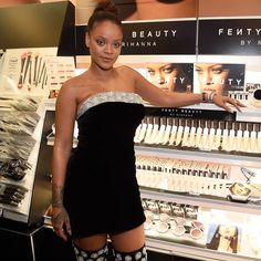 a woman standing in front of a display of cosmetics