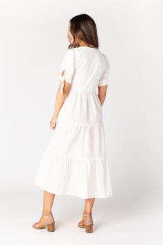 Lightweight woven swiss dot midi dress Notched neckline Short sleeves with ties Multiple gathered tiers Bodice is lined Fabric content - Cotton - Dry clean only recommended Maternity Pictures Dress, Proposal Dress, Prettiest Sunset, White Tiered Dress, Wedding Getaway, Getaway Dress, Called To Surf, Tie Sleeve Dress, Easter Dresses