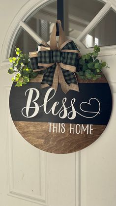 a door hanger that says,'bliss this home'with a bow on it