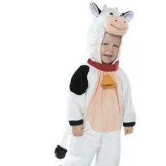 a child in a cow costume standing up