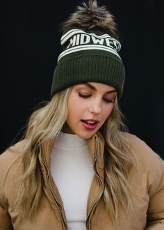 All of our Midwest people - this hat is for you! Our team designed this olive and beige pom hat with the true Midwesterner in mind. You'll keep grabbing this winter accessory time and time again this season.  Olive and ivory Midwest knit hat Natural faux fur pom accent Crown patch on the left side One size Designed in the U.S.A. Produced in China. 100% Acrylic Beanie Outfits, Stocking Hats, Pom Hats, Faux Fur Pom Pom, Pom Pom Hat, Pom Beanie, Fur Pom Pom, Cozy Fashion, Cozy Knits