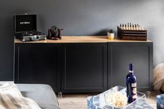 a living room with grey walls and furniture