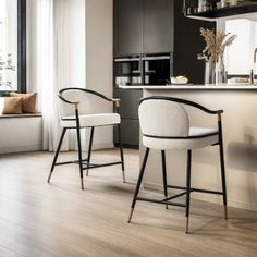 two bar stools sitting in front of a kitchen counter