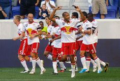 a group of men on a field playing soccer