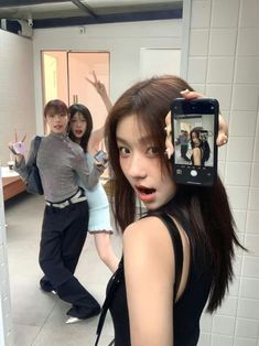 a woman taking a selfie in the mirror