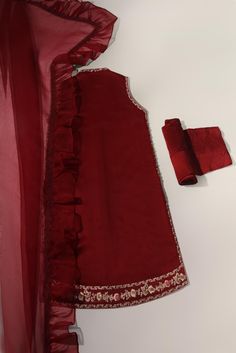 Canvassed on a jewel pomegranate tone of deep maroon in pure raw silk 58 Gms heavily embellished with embroidery details alongside hand/ada work, styled with matching trousers and pure frilly organza dupatta. Turns heads in this beautiful design. The length of the open shirt is 40 inches. Order Duration: 4 to 6 weeks Open Shirt, Deep Maroon, Organza Dupatta, Embroidery Details, Raw Silk, Pomegranate, Beautiful Design, Trousers, Embroidery