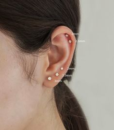 a woman with three different piercings on her ear