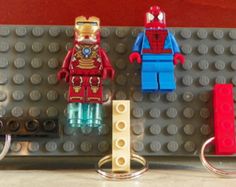 two lego iron man keychains sitting on top of a table