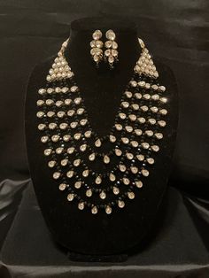 Rich Ethnic Taste is what this Item stands  for. Look elegant and stand out in crowd when U go out in this extraordinary design which is an ensemble of Multikundan, Multistranded gorgeous piece in white kundan and black beads.  Can't ask for more 🥰 White Kundan Necklace With Stone Work For Party, Elegant Black Kundan Necklace, Elegant Party Jewelry Sets With Mirror Work, White Kundan Necklace With Mirror Work For Party, Elegant Black Kundan Necklace For Celebrations, Festive Black Necklace For Party, Beaded Kundan Jewelry Sets For Party, Black Jewelry For Diwali Party, Festive Black Jewelry Sets For Party