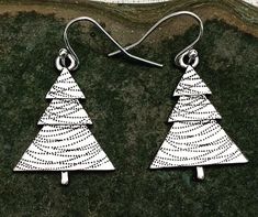 These are perfectly festive and exquisitely detailed silver Christmas tree earrings.  They are understated and classy.  The perfect go to holiday earrings.  These would make a very festive gift for a friend, loved one or secret Santa.The trees measure 1” long by 3/4” wide.  They hang from simple silver ear wire hooks.  Overall drop length is 1 1/8”.  Made from allergy free plated silver.I have a matching necklace in my shop if you would like the whole set.  Here is a direct link...........https: Nickel-free Sterling Silver Christmas Earrings, Nickel Free Silver Earrings For Christmas, Nickel-free Silver Earrings For Christmas, Nickel-free Sterling Silver Earrings For Christmas, Holiday Nickel-free Silver Earrings, Nickel Free Silver Earrings For Holiday, Nickel-free Silver Earrings For Holiday, Handmade Silver Holiday Earrings, Handmade Silver Christmas Earrings