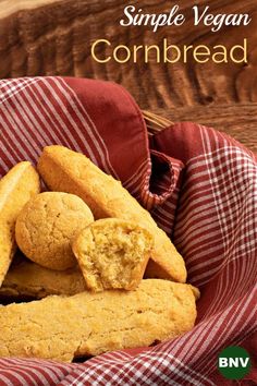 a basket filled with cornbreads on top of a red and white checkered cloth