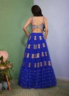 Editor's Note Introducing Artworq, a stunning iris blue lehenga designed to make you feel like royalty on your special day. Exquisitely crafted from a soft tulle base and embellished with shimmering glass crystals and intricate glass-cut beaded embroidery. The matching blouse features a stylish and modern cut, the piece comes with a matching dupatta, adorned with glass crystals and glass-cut beaded embroidery. Color: Blue Fabric: Tulle Neckline: V-neck Sleeve type: Sleeveless Embroidery details: Fitted Hand Embellished Organza Lehenga, Hand Embellished Fitted Organza Lehenga, Traditional Hand Embellished Blue Choli, Floor-length Skirt Set With Sheer Dupatta For Reception, Hand Embellished Floor-length Sets For Diwali, Blue Hand Embellished Sharara For Reception, Blue Hand Embellished Choli For Reception, Navratri Semi-stitched Hand Embellished Lehenga, Semi-stitched Hand Embellished Lehenga For Navratri