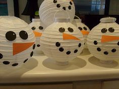 several paper snowmen sitting on top of a counter