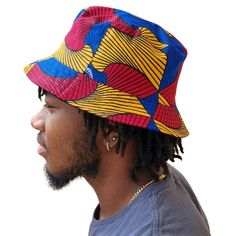 A unisex bucket cap made using authentic Ankara fabric. 58cm. Ankara, also known as African wax print or Dutch wax print, is a fabric characterized by vibrant patterns and colors. The fabric is made through a wax-resist dyeing technique called batik which creates distinct and colorful patterns. Ankara fabric is used to make a wide range of clothing and accessories, including dresses, skirts, shirts, and hats. Each pattern carries cultural meanings and stories making pieces made from this fabric not just fashion items but also carriers of African heritage and identity. Dutch Wax Print, Raffia Sun Hat, Resist Dyeing, Raffia Hat, African Heritage, Bucket Cap, Wax Resist, Vibrant Patterns, Colorful Patterns