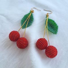 Stand Out with These Playful Cherry Earrings! Who's this for? Looking for a unique accessory to add a touch of personality to your outfit? These cherry earrings are the perfect choice for anyone who loves: Fun and playful jewelry Bright and vibrant colors Unique and eye-catching designs Comfortable and lightweight accessories Characteristics: Handmade with high-quality Czech glass beads Features vibrant red and green cherries Lightweight and comfortable to wear Gold-plated findings for a touch of elegance Versatile and can be paired with any outfit Why it's worth buying: Adds a pop of color and personality to any outfit Makes a perfect gift for a friend or loved one Crafted with attention to detail and high-quality materials Affordable and stylish Ready to add a touch of whimsy to your war Handmade Cherry Jewelry For Party, Trendy Cherry Dangle Earrings, Cherry Colored Earrings For Summer Party, Cherry Dangle Earrings For Party, Cherry Color Dangle Earrings For Party, Cherry Color Earrings For Summer Party, Trendy Red Beaded Earrings As Gift, Trendy Red Beaded Earrings, Trendy Red Beaded Earrings For Gift