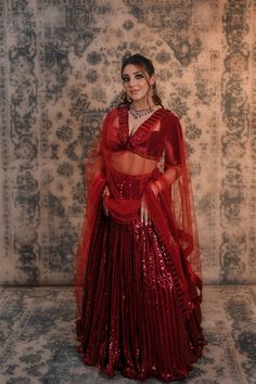 Power up your wardrobe collection with this maroon colour sequins work lehenga Ever thought of trying something different and appealing, this maroon coloured lehenga in sequined work can be a win-win choice for you. It comes along with a low-cut neckline silk velvet blouse which is decorated with bead tassels that will add a lot of oomph to your look. This amazing and stylish lehenga is designed keeping in mind your comfort and style statement. You must have heard that a lehenga is incomplete wi Elegant Red Lehenga With Sequins, Red Lehenga With Sequins In Traditional Drape, Red Lehenga With Sequins And Traditional Drape, Red Traditional Drape Lehenga With Sequins, Red Sequined Lehenga In Traditional Drape, Red Anarkali Choli With Sequins, Red Semi-stitched Sequined Lehenga, Sequined Party Wear Lehenga For Festive Season, Red Sequined Lehenga For Festive Occasions