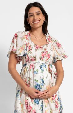 Perfect for a maternity photo shoot, this nursing-friendly midi dress is blooming with a colorful floral print that perfectly complements the fluttery sleeves. Stretchy shirred panels ensure a fit that grows with you, while discreet zippers allow easy access for nursing. Ties at back Sweetheart neck Short sleeves 51% cotton, 49% viscose Machine wash, line dry Imported Summer Dresses With Cape Sleeves And Floral Print, Floral Print Maternity Dress With Short Sleeves, Maternity Floral Print Flowy Midi Dress, Flowy Floral Print Maternity Midi Dress, Spring Maternity Dress With Floral Print For Brunch, Spring Maternity Midi Dress With Floral Print, Short Sleeve Floral Maternity Dress, Flowy Floral Print Maternity Dress, Floral Print Short Sleeve Maternity Dress