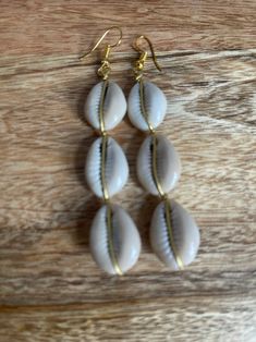 Authentic African Cowrie Seashell Long Dangle Earrings - Etsy Bohemian Beige Jewelry For Vacation, Handmade Cream Earrings For Beach, Natural Dangle Beach Jewelry, Gold Beaded Earrings For Beach, Beige Shell Jewelry For Beach, Natural Color Dangle Jewelry For Beach, Natural Dangle Jewelry For Beach, Elegant Beaded Dangle Earrings For Beach, Elegant Dangle Beaded Earrings For Beach