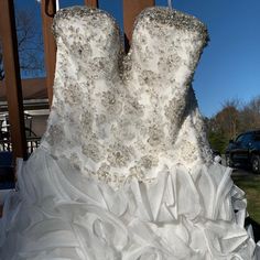 a white wedding dress is on display outside