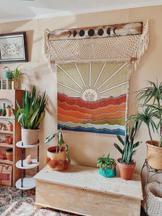 a living room filled with lots of plants and potted plants on top of a wooden table