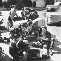 men working on an engine in the street