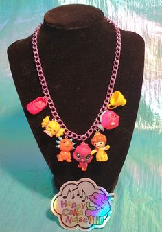 Stand out from the crowd with this unique Vintage toy necklace Featuring seven unique retro toys hung on a pretty coloured chain. The toys are a mix of plastic and soft rubber and very unique with lots of details.    The necklace is adjustable up to 42cms long with a lobster clasp closure. You will receive the exact item in the photographs, this is a one of a kind item which will never be replicated.   These little creatures will join you on many adventures and add a pop of fun and colour to any Pink Plastic Necklaces As Gifts, Pink Plastic Necklace Gift, Pink Plastic Necklace For Gift, Cute Handmade Plastic Necklace, Cute Multicolor Plastic Necklaces, Handmade Pink Plastic Necklace, Novelty Multicolor Necklaces For Birthdays, Multicolor Novelty Necklaces For Birthdays, Fun Multicolor Plastic Necklace