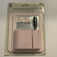 the accessory starter kit is pink in color and has a black handle on one end