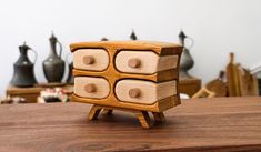 a wooden toy with four drawers on it