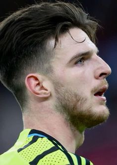 a close up of a soccer player wearing a yellow uniform