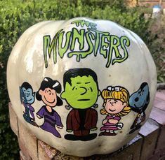 a white pumpkin decorated with cartoon characters and the words'the monsters'painted on it