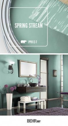 the interior of a bathroom painted in green and white