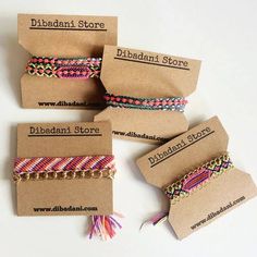 four bracelets with different colors and designs are on brown paper tags that say, diffadani store