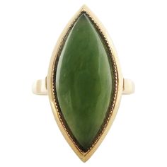 This is a captivating 14K Yellow Gold Ring, featuring an exquisite Nephrite Jade cabochon. The stone is an exceptional 21 mm x 9 mm. The under gallery is constructed with enchanting filigree detailing that allows light to come through the jade, causing it to practically glow. It is a significant ring, however, it does not take over the hand. Despite the size of the ring, you will find that it is rather comfortable, especially for everyday use. Currently, this ring is sized at an 8, but can easil Arrowhead Ring, Green Jade Ring, Engraved Bangle Bracelet, Three Stone Diamond, Gold And Green, Nephrite Jade, Jade Ring, Dress Rings, Antique Diamond