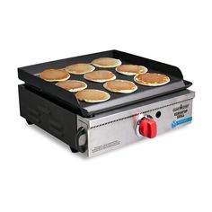 an electric griddle with pancakes cooking on it