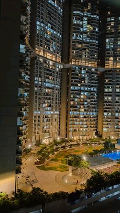 an aerial view of a city at night with skyscrapers lit up in the background