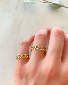 Dress up your everyday basics with this Cuban Chain Ring, expertly crafted in glowing 14K gold with the option of Diamonds. Add a couple of delicate fine rings to this beauty!! Your chain necklaces can now be paired with a sleek matching ring. This modern-luxe link band adds instant sophistication. Metal: 14K Yellow Gold (Stamped) Chain Width: 5 mm Stone: Diamonds Size Option: 6, 6.5, 7, 7.5, 8, 8.5 Gold Everyday Diamond Ring Tarnish Resistant, Gold Hypoallergenic Midi Rings For Promise, Gold Plated Yellow Gold Open Chain Ring, Yellow Gold Plated Open Chain Ring, Gold Open Chain Ring Tarnish Resistant, Gold Plated Tarnish-resistant Open Chain Ring, Gift Chain Link Ring With Adjustable Chain, Adjustable Open Ring With Chain Detail, Adjustable Open Chain Ring