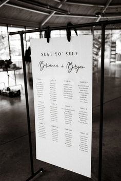 a seating chart hanging on a metal stand