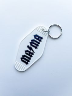 a bottle shaped keychain with the word abara printed on it