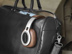 headphones on top of a black leather bag