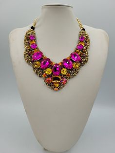 Each piece of our statement necklaces is handmade and one of a kind made in Italy. Our creations is made of high quality materials such as crystals and rhinestones. Each embroidered material is carefully hand sewn. Very glamorous and stylish. Perfect gift to someone you like. Materials Strass stone and Rhinestone in Fuchsia, Gold, Astral Pink and Light Topaz color in different dimension.  Black satin fabric backing. Aluminium chain with lobster closure. Measurements Weight approximate 200 grams. Chain lenght 25 cm - 9.84 in Circumference approximate 63 cm - 24.80 in Feel free to contact us if you have any question. Thank you so much for looking at our shop and our articles each of them, single piece. Multicolor Crystal Necklace With Rhinestones, Multicolor Rhinestone Necklace With Sparkling Stones For Party, Crystal Jeweled Necklaces For Celebration, Multicolor Jeweled Beaded Necklace For Party, Multicolor Crystal Beaded Necklaces For Party, Multicolor Crystal Necklaces For Parties, Multicolor Crystal Necklace With Sparkling Stones, Pink Jeweled Rhinestone Necklace For Party, Costume Rhinestone Necklace For Gifts