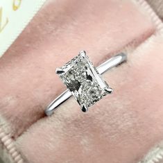 an engagement ring with a princess cut diamond