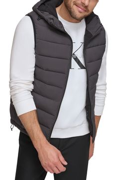 Easy to layer, this puffer-style vest features an attached hood that furthers the comfort. Attached hood Sleeveless 100% polyester Machine wash Imported Model stats: 6'1" height, 32" waist. Model is wearing size M. Hooded Puffer Vest For Fall, Functional Hooded Nylon Vest, Hooded Nylon Vest For Outdoor, Hooded Nylon Vest For Outdoor Activities, Fall Sleeveless Outerwear With Detachable Hood, Winter Nylon Vest With Detachable Hood, Sporty Nylon Vest For Winter, Spring Nylon Puffer Vest, Hooded Puffer Vest For Outdoor