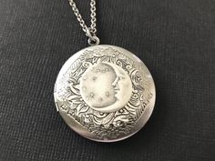 "Celestial Floral Locket Necklace....  This beautiful vintage style locket is a round antique silver floral brass locket.  I have added an antique silver plated floral disc to the center of the locket.  On top of the disc, I attached a stars and crescent moon brass stamping. I have this celestial locket suspended from an antique silver plated brass rolo chain with soldered links.  The chain is non tarnish and closes with a lobster claw clasp.  You will LOVE wearing this locket!   The moon and st Moon Locket Necklace, Viking Ceremony, Celestial Floral, Chain Locket, Stars Vintage, Photo Area, Dream Items, Vintage Jewlery, Whimsical Jewelry