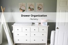 a baby's nursery room with the name drawer organization