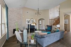 a living room filled with furniture and a chandelier