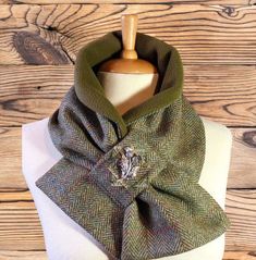 PLEASE READ THIS DESCRIPTION CAREFULLY BEFORE ORDERING. NEW FOR AUTUMN WINTER  A simply stunning Harris Tweed® herringbone tweed neck warmer with a khaki/olive green fleece lining. A beautiful green herringbone with An over check in mustard, blue and rust. Looking more closely there are a myriad of other colours too. These snoods are hand made by myself and are a fabulous alternative to a bulky scarf. Very easy and simple to wear. The thistle brooch is included and can be removed to wear on othe Harris Tweed Crafts, Thistle Brooch, Sewing Scarves, Bulky Scarf, Tweed Scarf, Fleece Neck Warmer, Fleece Scarf, Herringbone Tweed, Couture Mode