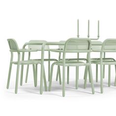 the table and chairs are all in pastel green