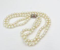 Circa 1950's.  Very pretty double strand of 113 (one hundred thirteen) 6.0 to 6.3 round cultured saltwater pearls.  The pearls are attached to an engraved silver clasp set with a pink paste stone.  This is such a nice classic pearl length and can easily be worn dressed up or for everyday.  A lovely wedding necklace.  They have just been professionally restrung. These pearls are accompanied by an independent written appraisal GIA/GG cert. Appraisal Value: $2,300.00 Vintage Akoya Pearl Necklace For Formal Occasions, Formal Vintage Akoya Pearl Necklace, Formal Antique Pearl Drop Necklace, Vintage Akoya Pearl Necklace, Vintage Pearl Necklace With Pearl Charm For Formal Occasions, Vintage Akoya Pearl Drop Necklace, Vintage Akoya Pearl Necklace For Anniversary, Vintage Akoya Pearl Jewelry With Round Beads, Vintage Akoya Pearl Beaded Jewelry